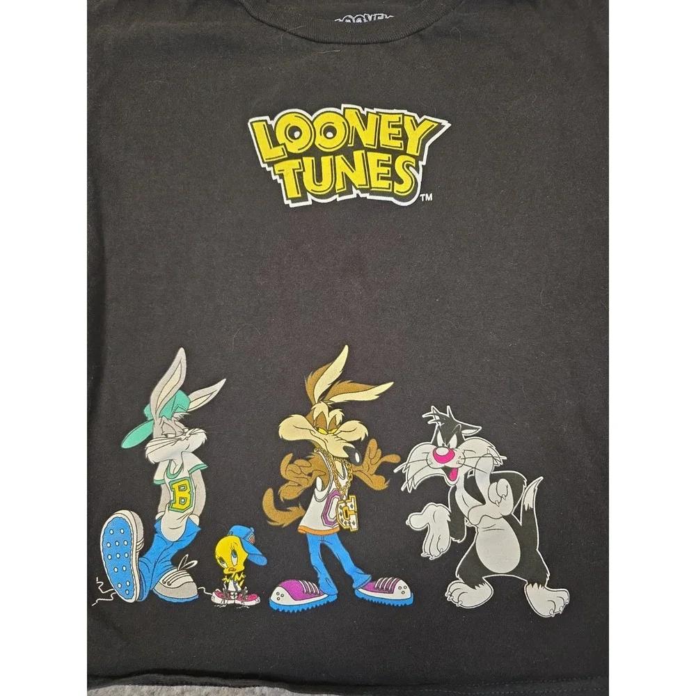 black Looney Tunes t-shirt features a graphic of Bugs Bunny, Wile E. Coyote,...